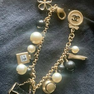 Authentic Chanel faux pearl charm bracelet. pearls have wear, please see photos.